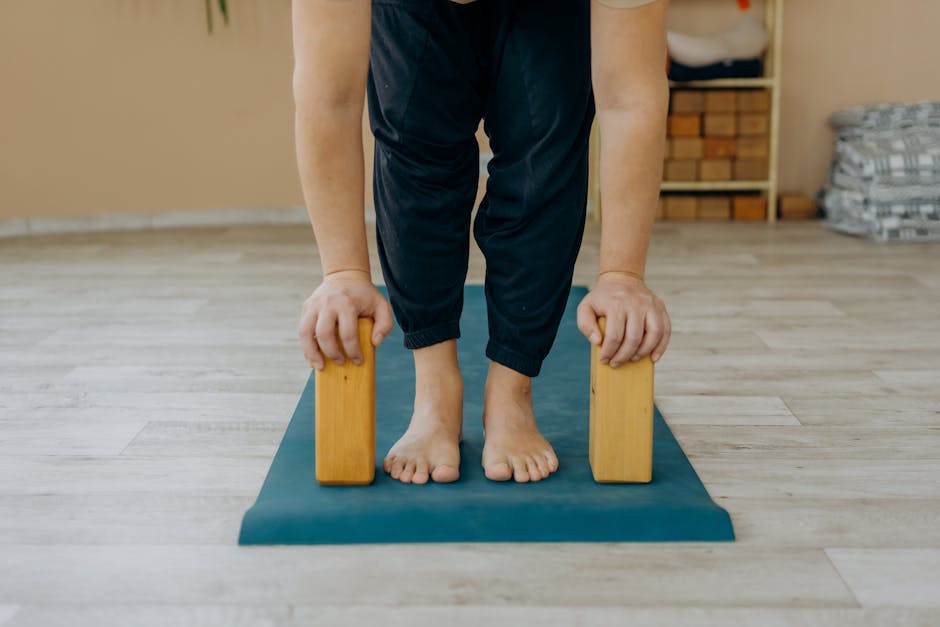 Person doing a challenging arm balance on a yoga mat.