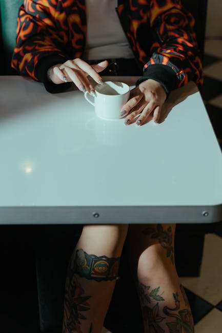 Profile of a focused person sitting with crossed legs and hands on knees.